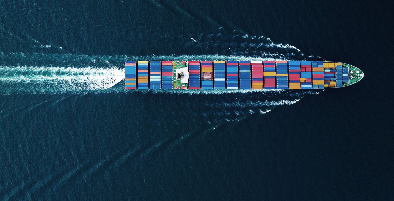 Cargo ship at sea representing maritime IoT connectivity for vessels and offshore operations