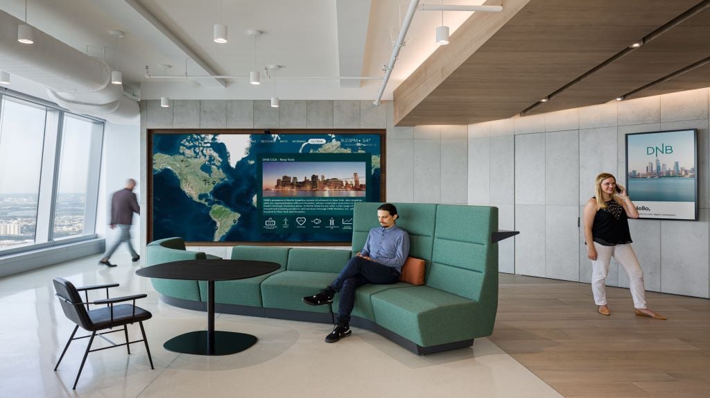 Digital signage screen from ZetaDisplay operating in a professional office environment, enabled by reliable Com4 IoT connectivity.