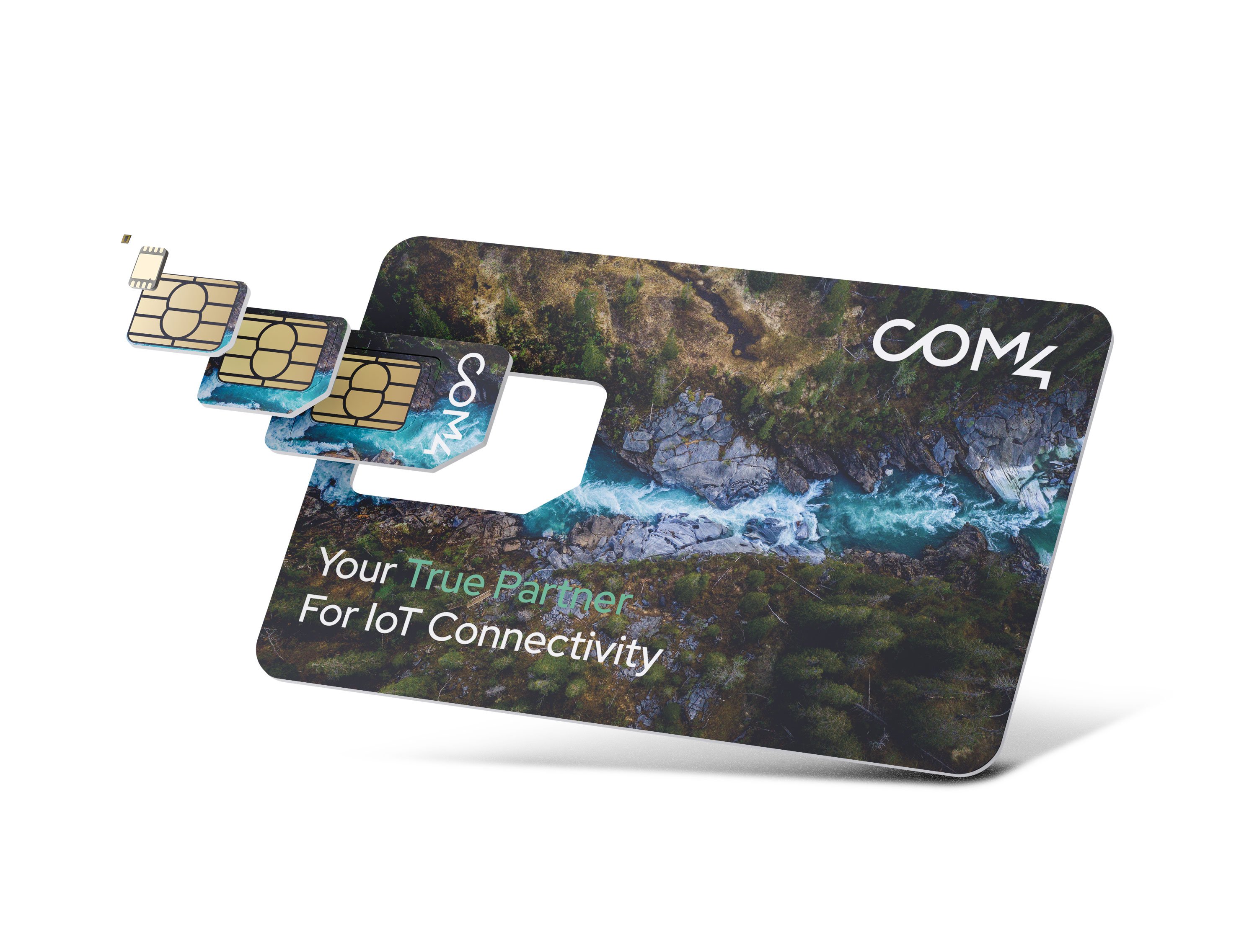 Com4 SIM card triple-cut punch-out card featuring an aerial photo of a river cutting through a Nordic forest, with the tagline 'Your True Partner For IoT Connectivity,' and Mini, Micro, and Nano SIM formats detached and fanned out beside it.