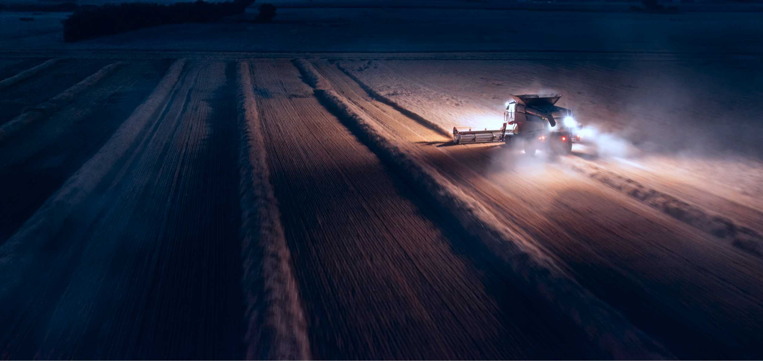 Combine harvester at night
