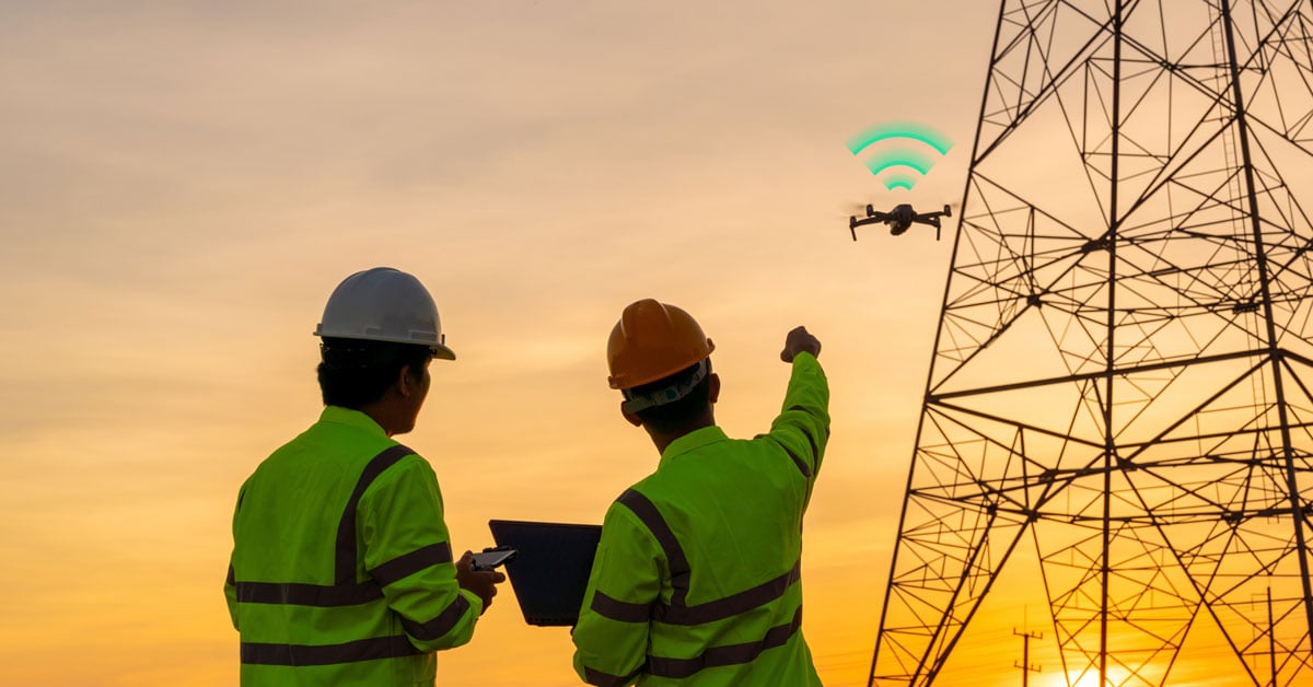 Engineers deploying drones with cellular IoT connectivity for energy and utility grid inspection