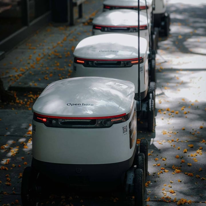 Industry 4.0 food production with robots transferring goods using cellular IoT connectivity.