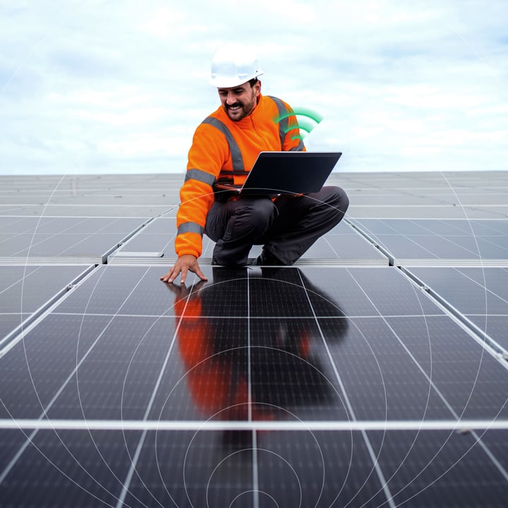 Solar energy engineer repairing solar panels with IoT connectivity monitoring system