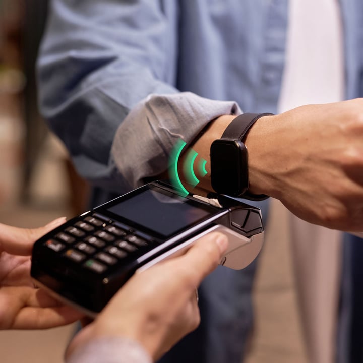 Smartwatch making a wireless payment via POS terminal