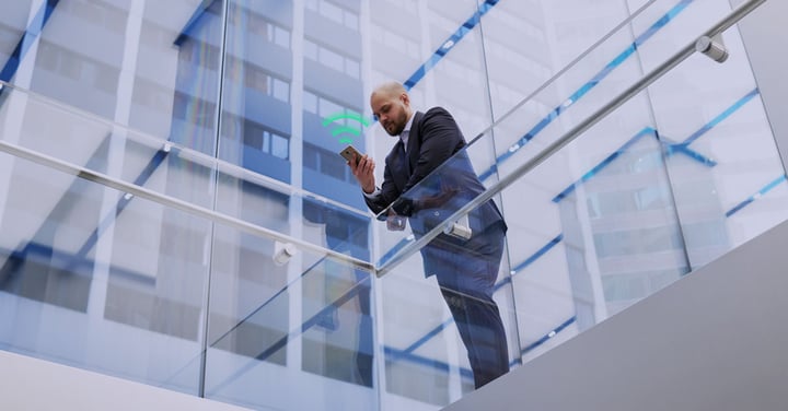 Business professional using a smartphone in a modern office building