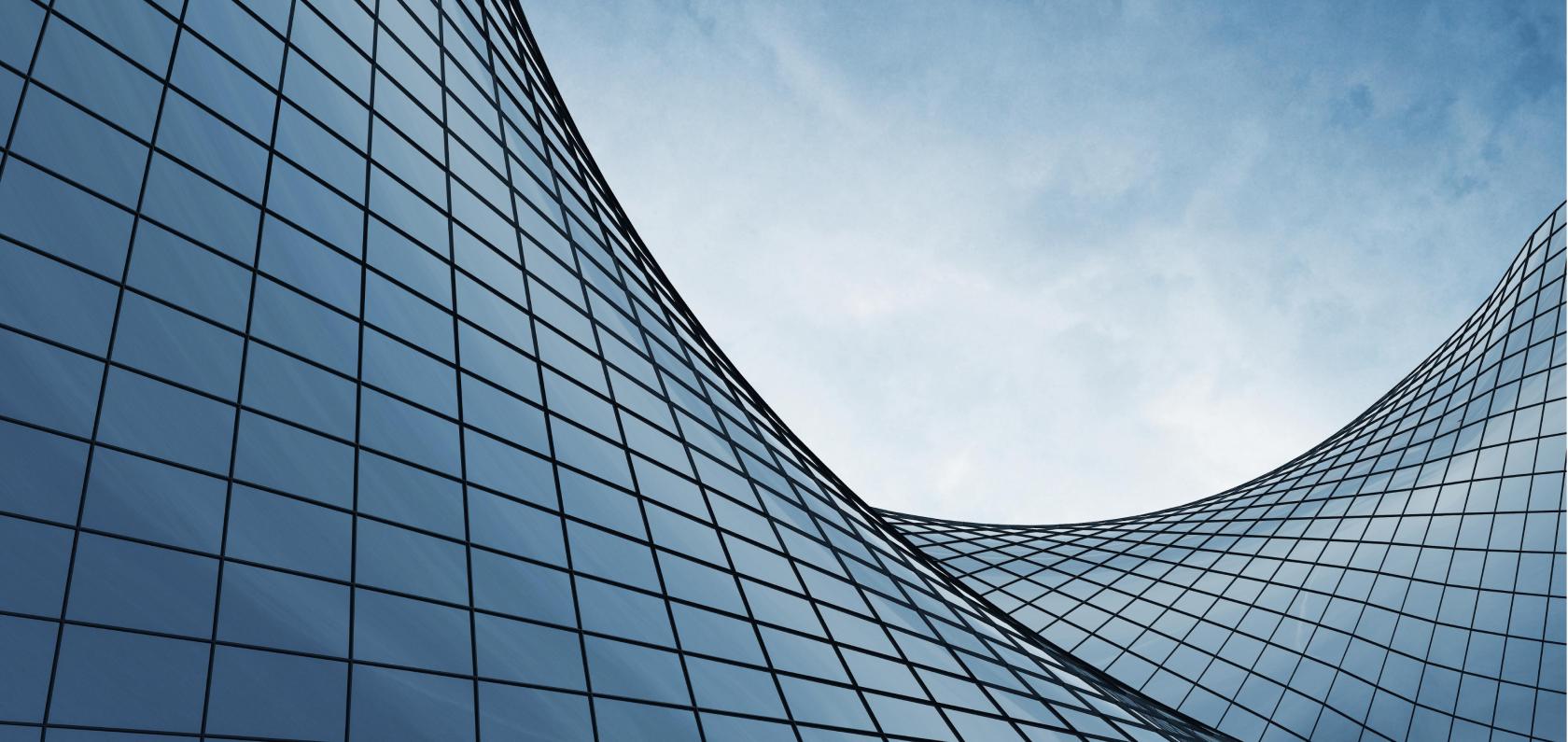 Modern glass office building representing connected smart buildings
