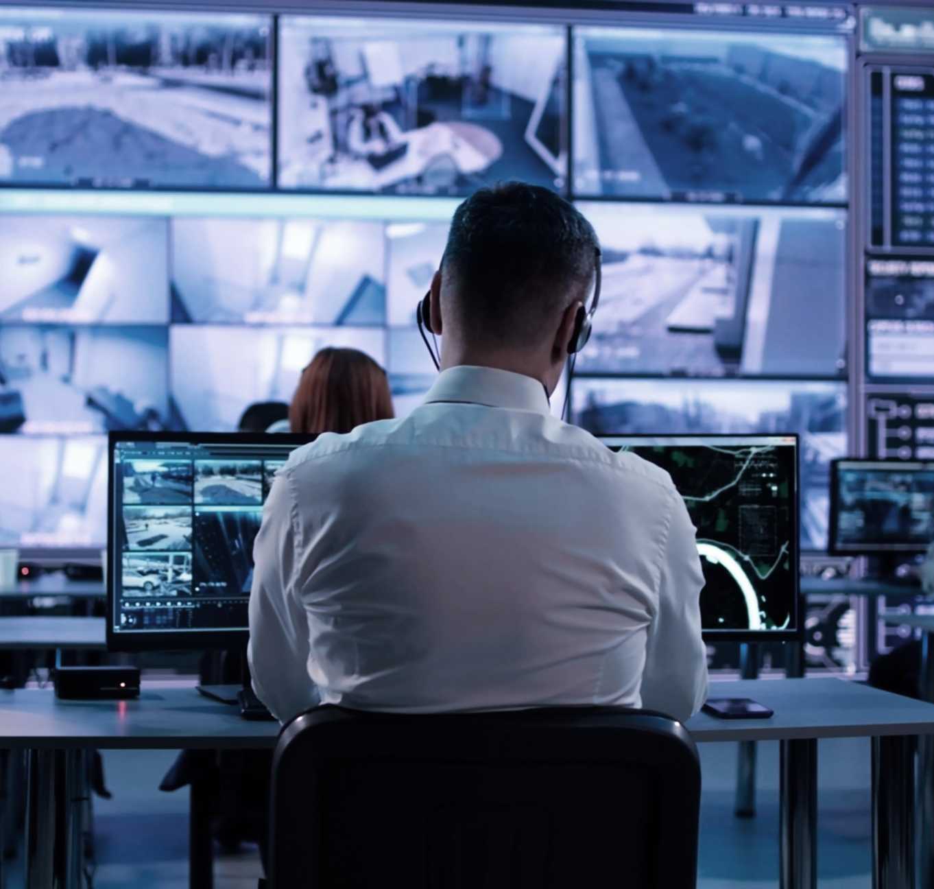 Man with headset infront of screens small