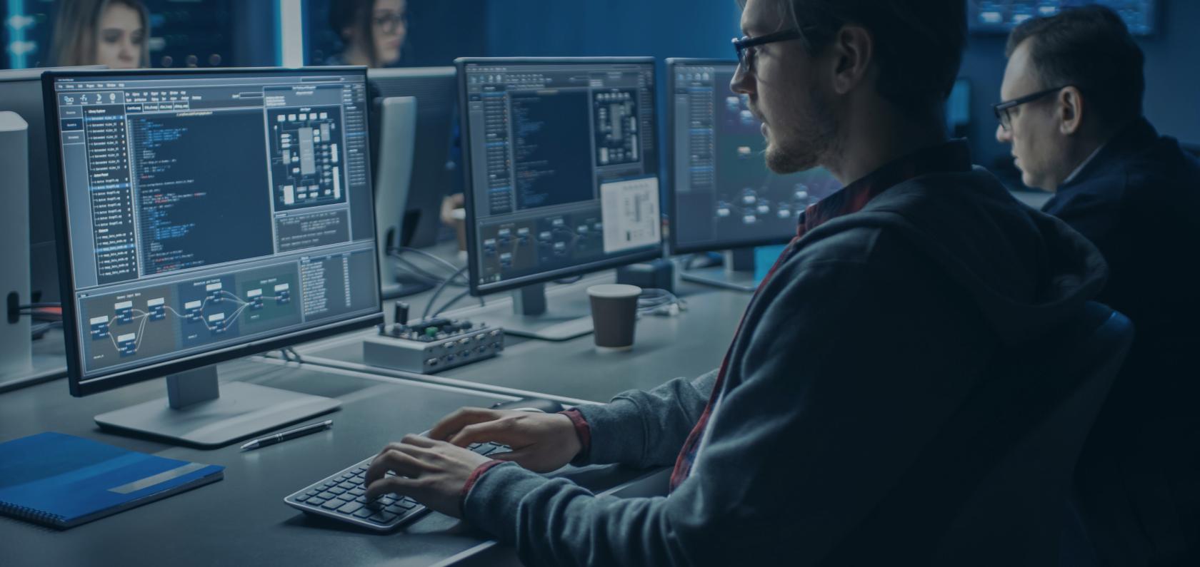 Security team monitoring computer screens representing IoT security operations