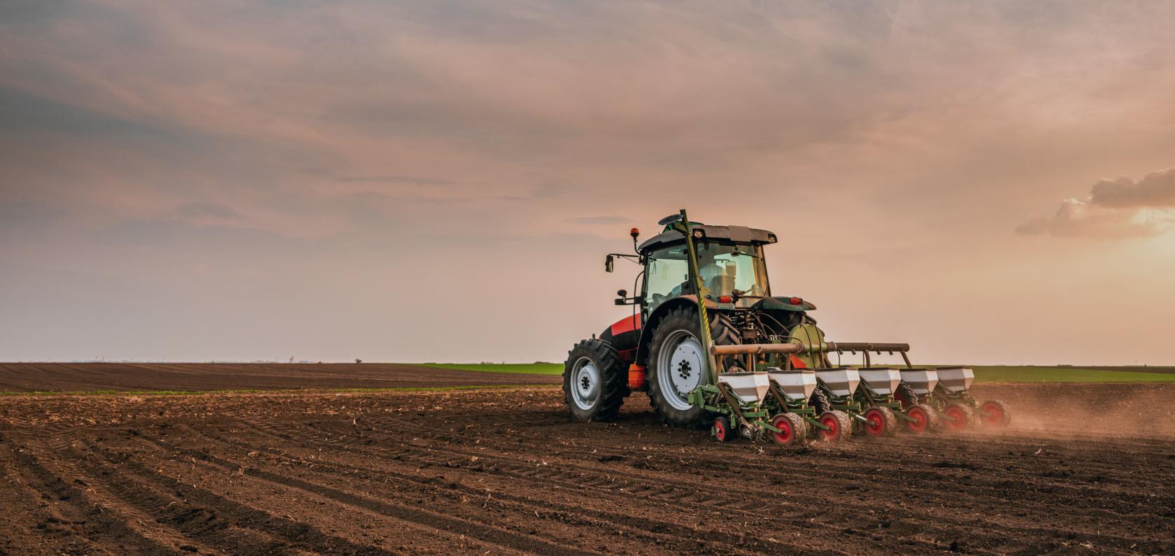 Tractor working in a field representing modern agriculture with IoT technology