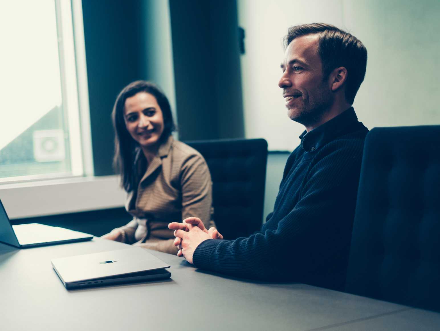 Woman and man in meeting room