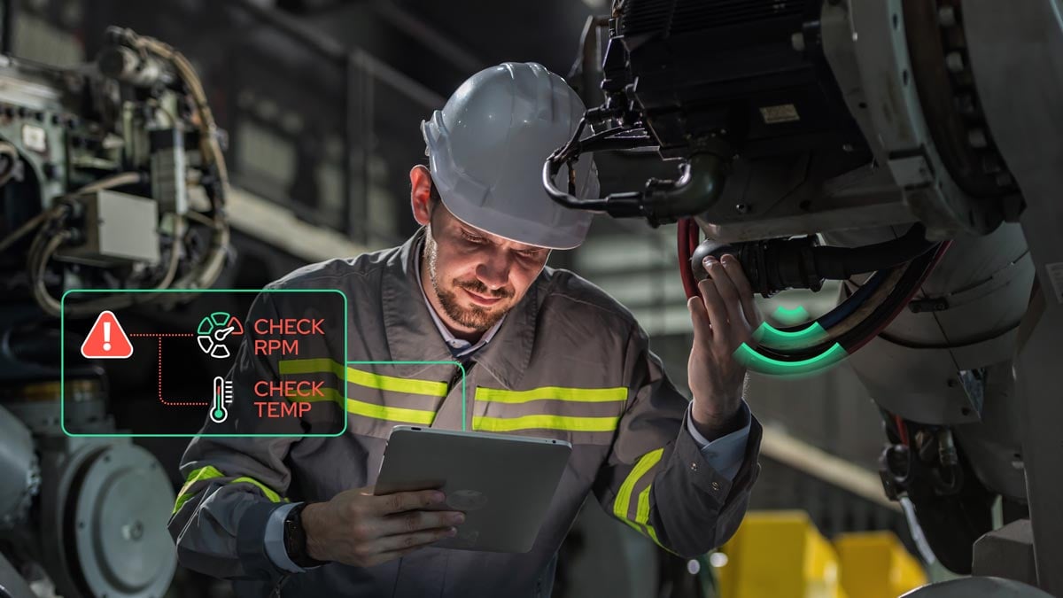 Industrial engineer analyzing IoT sensor data for predictive maintenance on factory machinery.