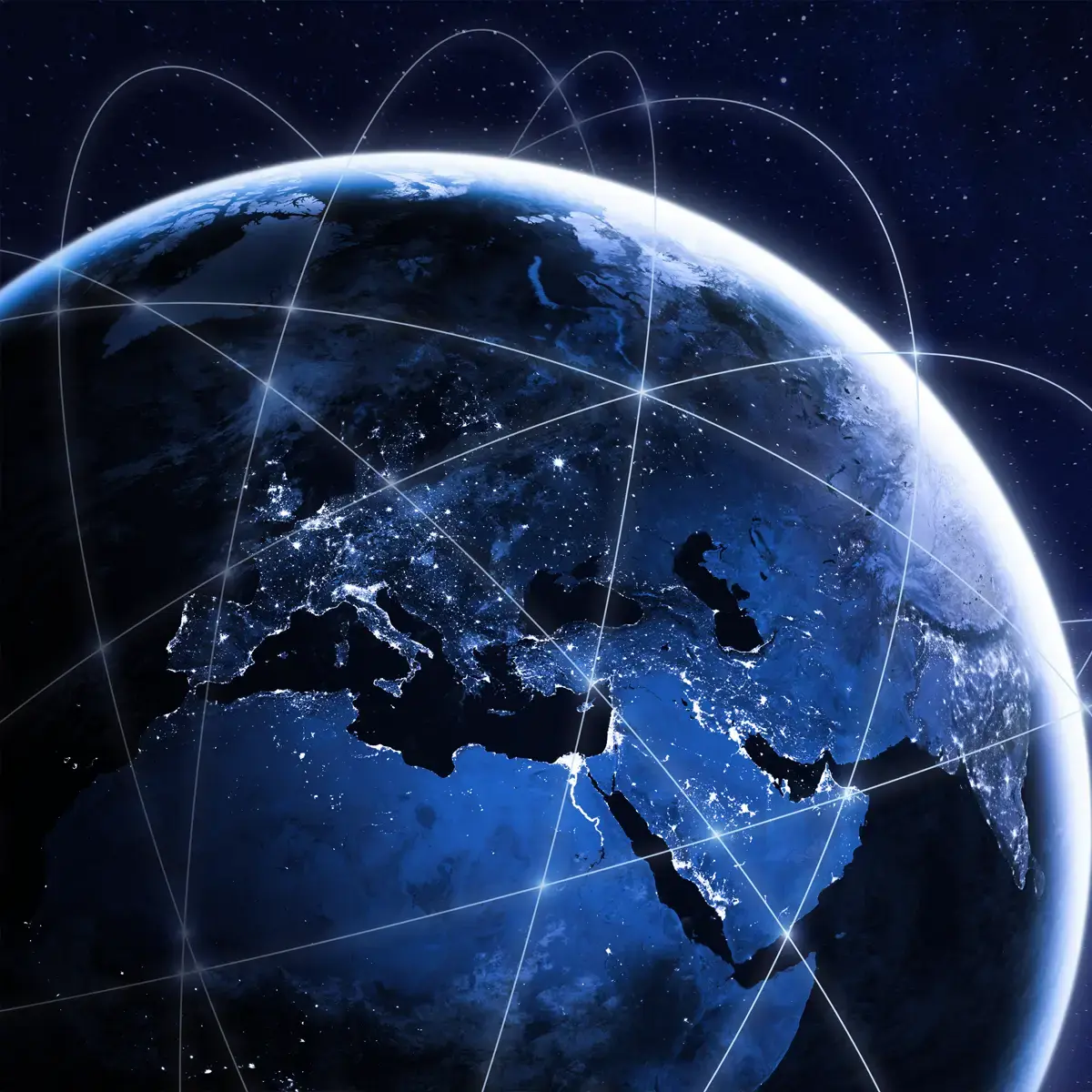 Nighttime view of Earth from space showing Europe, the Middle East, and North Africa illuminated with city lights, encircled by a network of satellite connection lines representing global coverage via Non-Terrestrial Network (NTN) technology.